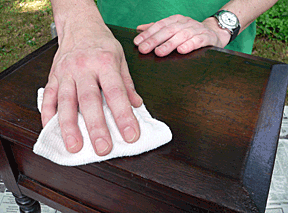 Cleaning furniture with a dry cloth.